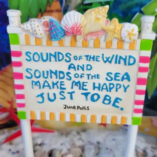the sounds of the wind beach sign