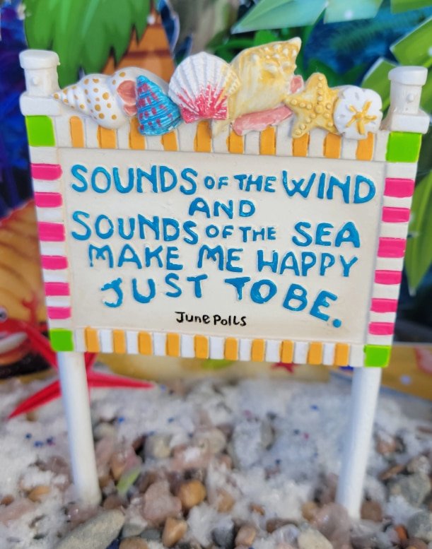 the sounds of the wind beach sign