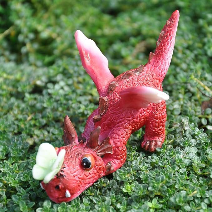 mini red dragon playing with butterfly